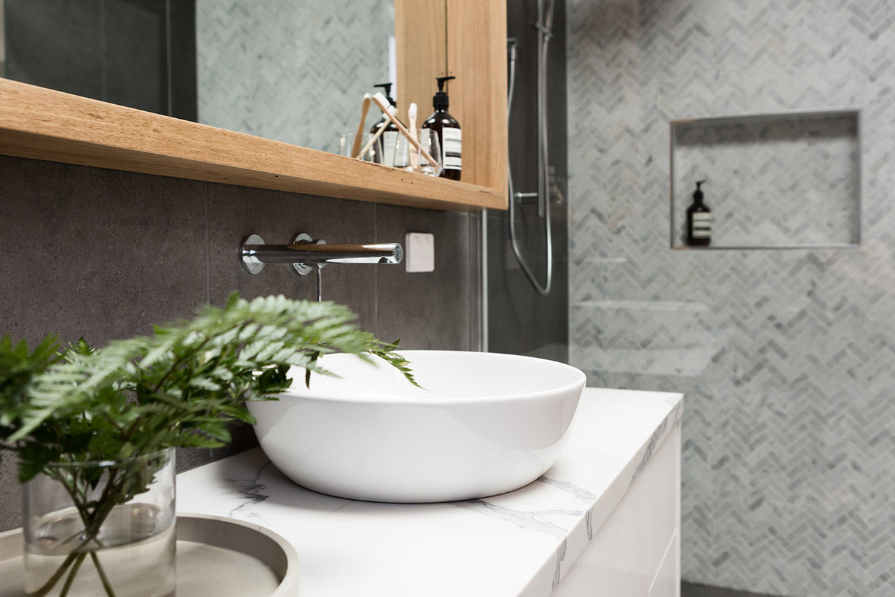 Bathroom details clean white basin with shower tiling behind stock photo