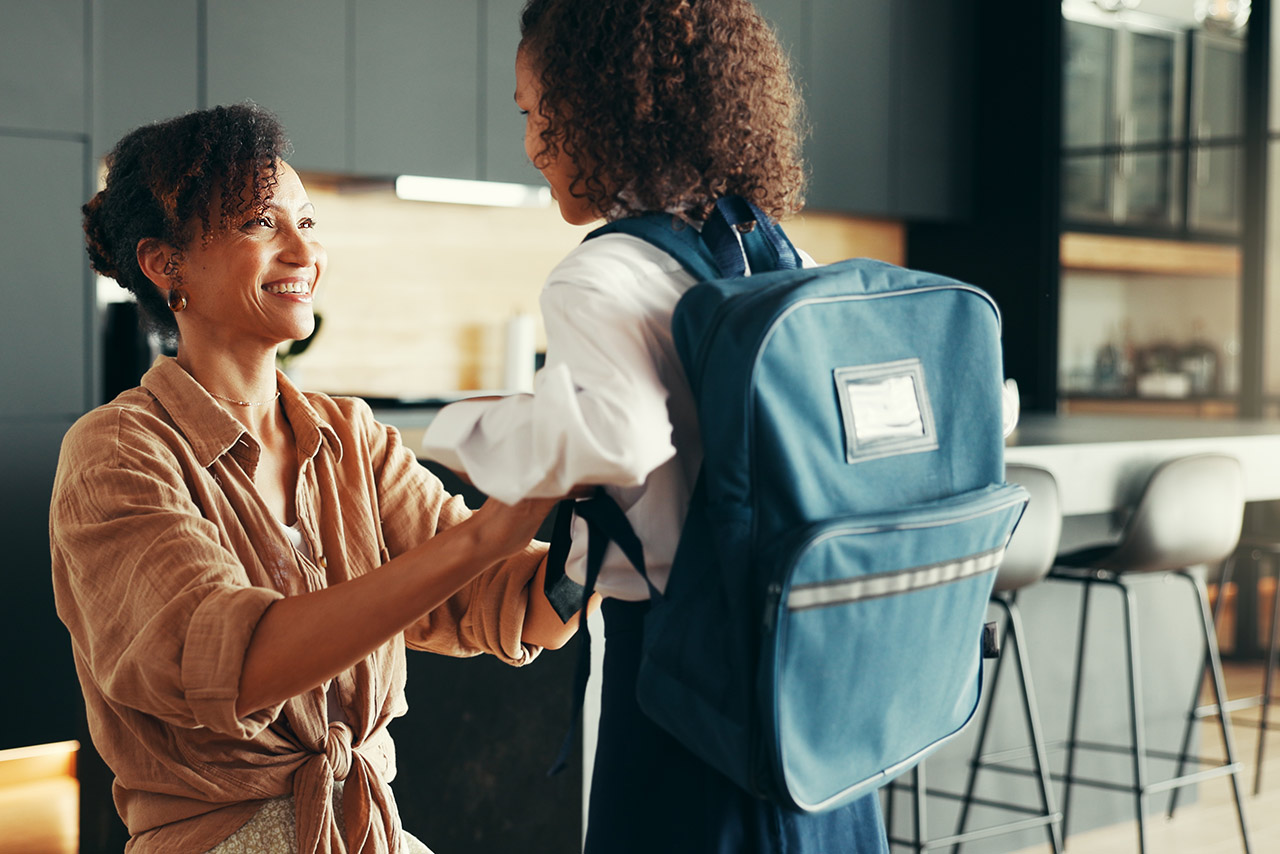 Mom, girl and happy with school uniform in home getting ready for a school day stock photo